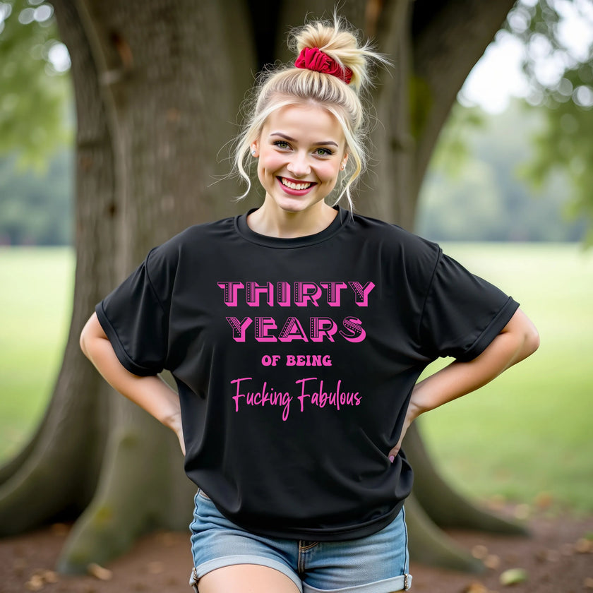 Woman wearing ‘30 Years of Being Fucking Fabulous’ black birthday t-shirt, bold pink mixed-font lettering, confident and playful 30th birthday celebration vibe.