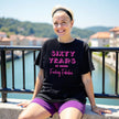 Woman wearing black ‘60 Years of Being Fucking Fabulous’ birthday t-shirt with bold pink mixed-font lettering, confident and playful 60th birthday celebration vibe.