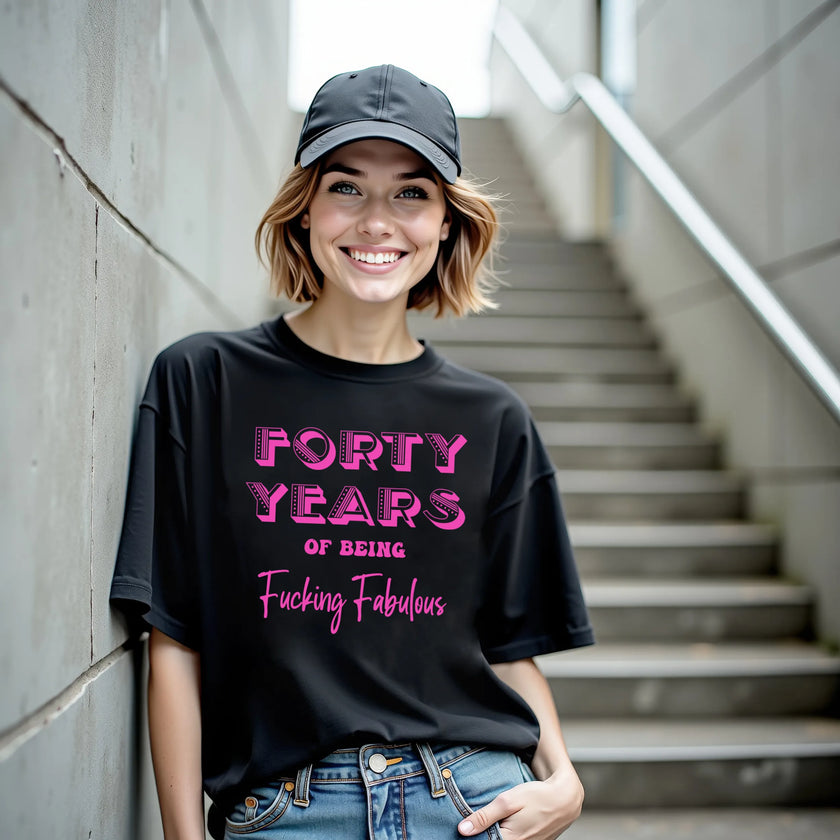Woman wearing black ‘40 Years of Being Fucking Fabulous’ black birthday t-shirt, bold pink mixed-font lettering, confident and playful 40th birthday celebration vibe