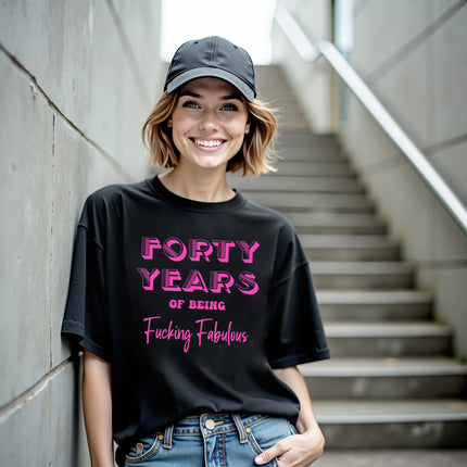 Woman wearing black ‘40 Years of Being Fucking Fabulous’ black birthday t-shirt, bold pink mixed-font lettering, confident and playful 40th birthday celebration vibe