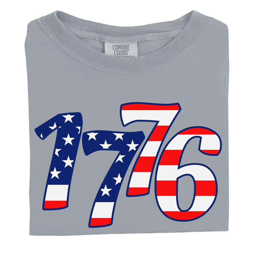 1776 patriotic t-shirt in gray, showing large flag-filled numbers in red white and blue, bold Fourth of July graphic tee for summer celebrations.