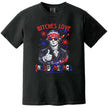 Funny ‘Bitches Love Independence’ t-shirt in black, featuring Thomas Jefferson in sunglasses and flag bandana giving a thumbs up with fireworks and star sparkles