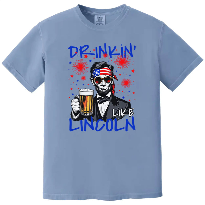 Drinkin Like Lincoln patriotic t-shirt in blue, funny Lincoln drinking graphic with patriotic sunglasses and beer mug, bold July 4th party tee.