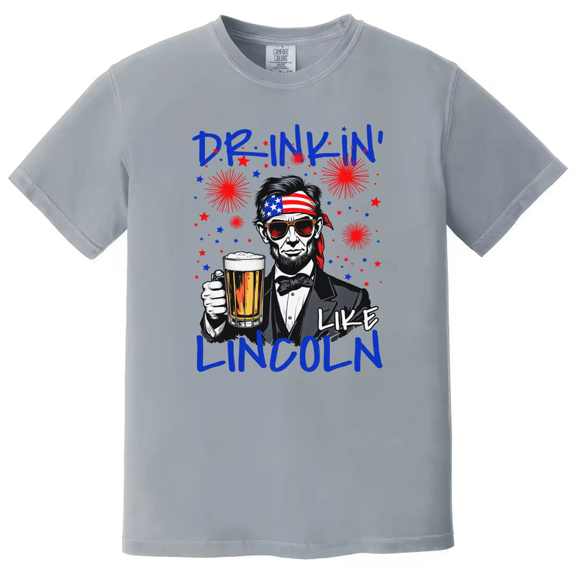 Drinkin Like Lincoln patriotic t-shirt in gray, humorous Lincoln graphic with beer mug and patriotic accessories, July 4th BBQ and party shirt.