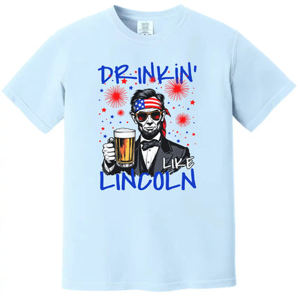 Drinkin Like Lincoln patriotic t-shirt in light blue, Abraham Lincoln wearing sunglasses and bandana holding beer, fun Independence Day graphic tee
