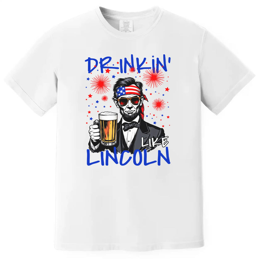 Drinkin Like Lincoln patriotic t-shirt in white, Abraham Lincoln graphic with sunglasses, bandana, and beer, humorous Independence Day shirt for summer parties