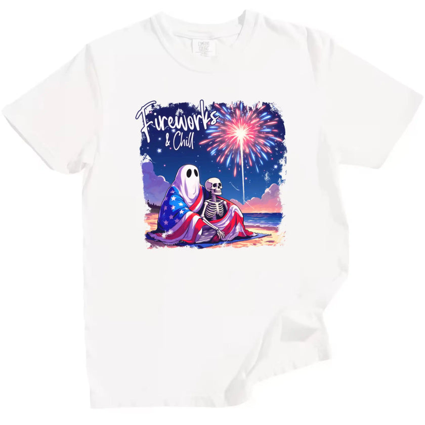 Fireworks and Chill patriotic t-shirt in white, adorable ghost and skeleton couple cuddling on beach under flag blanket with fireworks, fun Independence Day tee