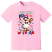 Cute July 4th t-shirt in pink, goose holding American flag and hot dog, ‘Just Here for the Wieners’ funny BBQ graphic tee.