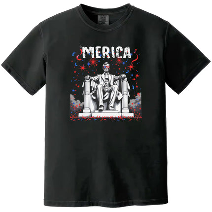 Funny patriotic ‘Merica t-shirt in black, featuring Abraham Lincoln in seated pose with flag sunglasses and fireworks in the background, July 4th graphic tee.