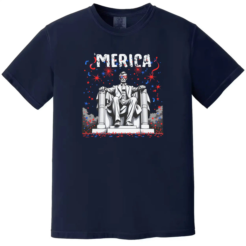 ‘Merica July 4th t-shirt in navy, Abraham Lincoln graphic with sunglasses and fireworks sky, laid-back patriotic summer tee