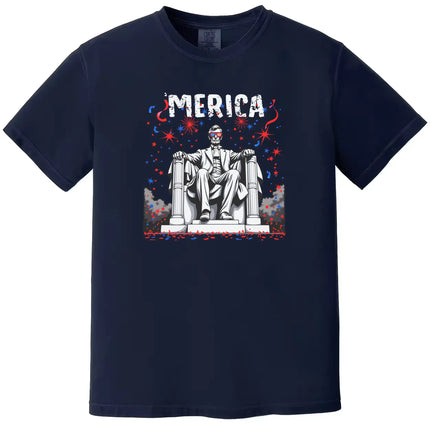 ‘Merica July 4th t-shirt in navy, Abraham Lincoln graphic with sunglasses and fireworks sky, laid-back patriotic summer tee