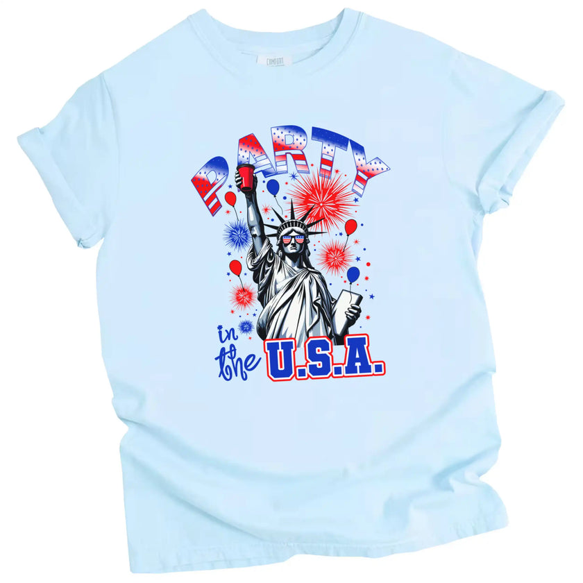 Statue of Liberty party graphic t-shirt in light blue, holding red cup instead of torch with fireworks and stars, fun Independence Day tee