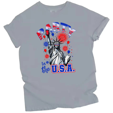Funny Statue of Liberty graphic tee in gray, holding red cup with fireworks and sparkles in sky, patriotic July 4th party shirt.