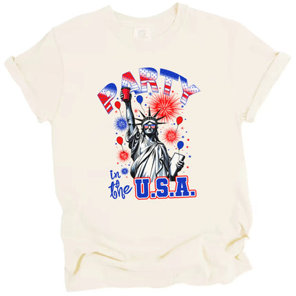 Funny July 4th Statue of Liberty tee in cream, Liberty with red party cup and sunglasses under fireworks and sparkles, patriotic summer shirt.