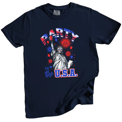 Patriotic ‘Party in the USA’ t-shirt in navy, Statue of Liberty holding drink cup, flag sunglasses, fireworks background July 4th shirt.