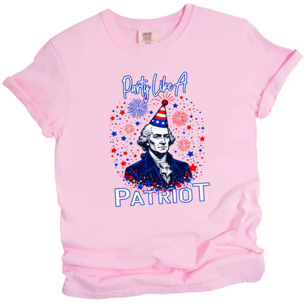“‘Party Like a Patriot’ t-shirt in pink, George Washington bust wearing patriotic party hat with fireworks and sparkles, funny July 4th graphic tee