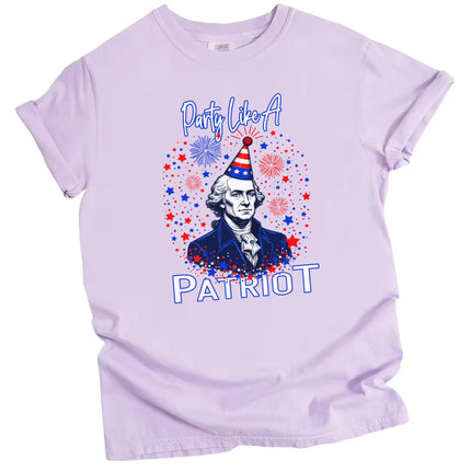 Funny patriotic t-shirt in purple featuring George Washington bust with party hat, fireworks and sparkles, playful July 4th graphic tee.