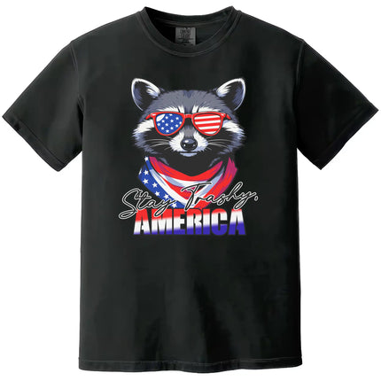 Funny July 4th t-shirt in black featuring raccoon with sunglasses and bandana, ‘Stay Trashy America’ patriotic graphic tee.