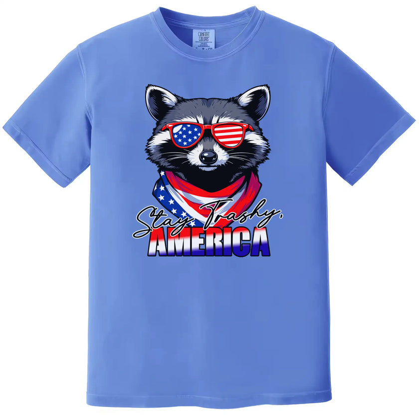 Funny raccoon patriotic t-shirt in blue with ‘Stay Trashy America’ text, sunglasses and flag bandana design for July 4th parties.”