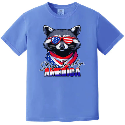 Funny raccoon patriotic t-shirt in blue with ‘Stay Trashy America’ text, sunglasses and flag bandana design for July 4th parties.”