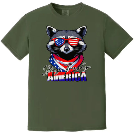 Stay Trashy America t-shirt in green, raccoon wearing flag sunglasses and bandana, funny patriotic July 4th animal graphic tee.