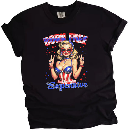 Born Free But Now I’m Expensive patriotic t-shirt in black, retro pinup girl in patriotic bustier giving peace sign, funny July 4th party graphic tee