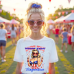 Female model wearing white ‘Born Free But Now I’m Expensive’ t-shirt, retro pinup girl with patriotic outfit and sunglasses, confident July 4th party vibe.