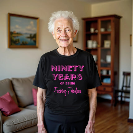 Woman wearing black ‘90 Years of Being Fucking Fabulous’ birthday t-shirt with bold pink mixed-font lettering, confident and playful 90th birthday celebration vibe.
