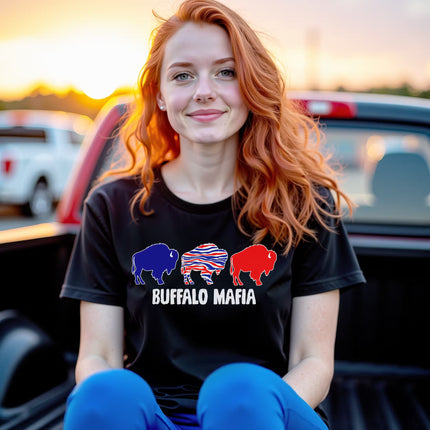 Woman wearing black Buffalo Mafia football t-shirt with three buffalo graphic, styled for game day fanwear, sitting in back of pickup truck.