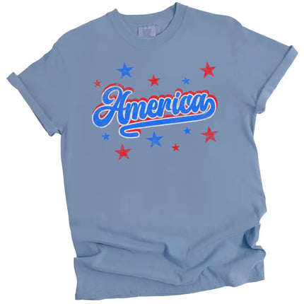 Retro America graphic tee in blue, bold distressed font with red white blue outlined lettering and subtle star sparkles.