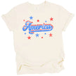 Vintage patriotic America tee in cream, distressed lettering with bold red white blue outline and subtle star sparkle accents.