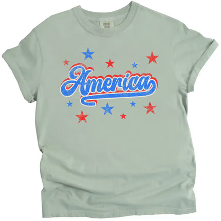 Patriotic America t-shirt in green, vintage-style distressed lettering with red white blue colorblock outline and star accents.