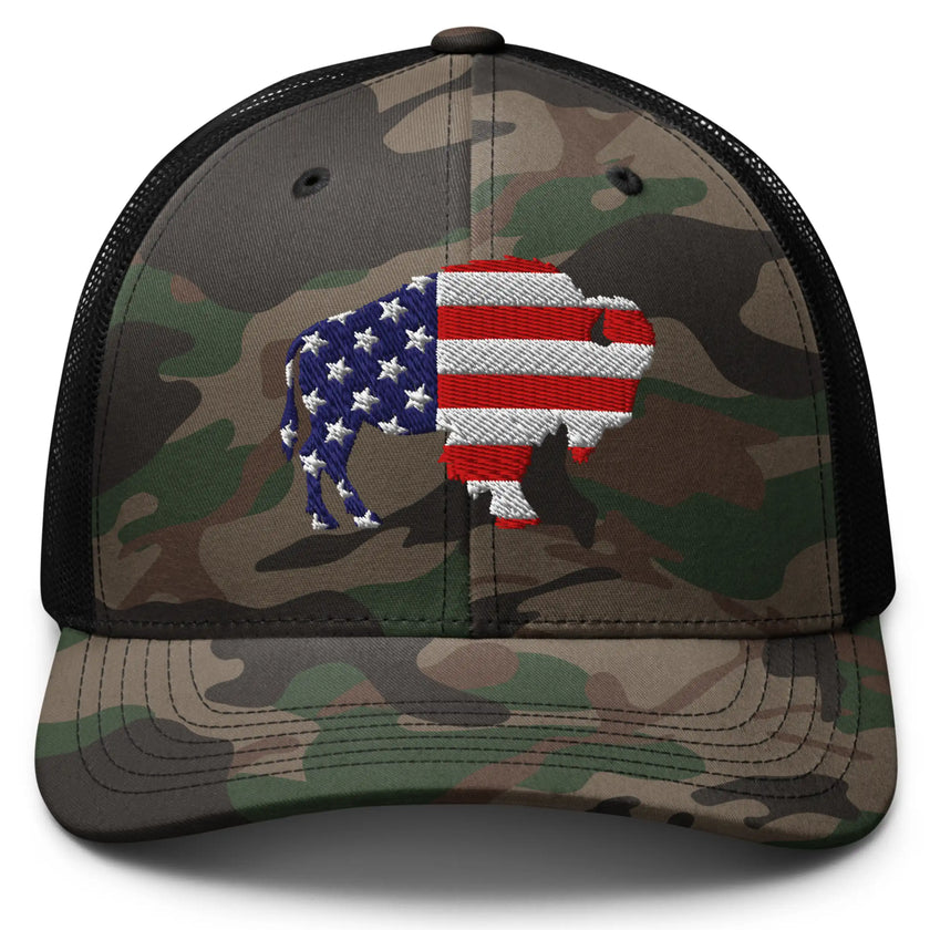 Buffalo camo trucker hat featuring embroidered American flag buffalo silhouette on front panel, patriotic Buffalo city pride hat with rugged outdoor style.