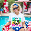 Female model wearing white Beach Babe neon summer t-shirt in pool, tropical palm tree smile face design, fun beach vacation vibe.