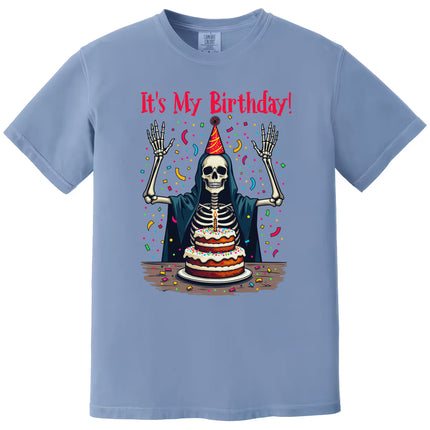 Blue “It’s My Birthday” skeleton t-shirt flat lay featuring skeleton with party hat and falling confetti, bold and playful birthday graphic