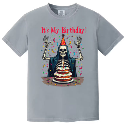 Gray “It’s My Birthday” skeleton t-shirt flat lay showcasing skeleton in party attire with confetti, perfect for birthday celebrations