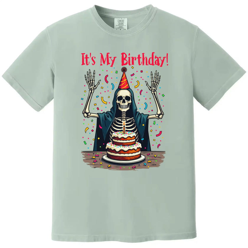 Green “It’s My Birthday” skeleton t-shirt flat lay with festive skeleton illustration and confetti, fun birthday party design
