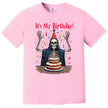 Pink “It’s My Birthday” skeleton t-shirt flat lay with cheerful skeleton, confetti, and party hat, fun and sarcastic birthday tee