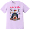 Purple “It’s My Birthday” skeleton t-shirt flat lay featuring party skeleton with cloak, confetti, and hat, playful birthday style