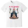 White “It’s My Birthday” skeleton t-shirt flat lay with party hat, cloak, and confetti design, playful and cheeky birthday graphic