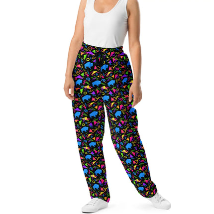 Woman wearing Buffalo retro neon pants featuring colorful geometric shapes and blue buffalo silhouettes, unique 80s and 90s inspired Buffalo NY fashion.