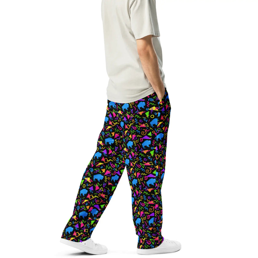 Right side view of Buffalo neon print pants featuring vibrant geometric shapes, retro squares, circles, triangles, and blue buffalo silhouettes.