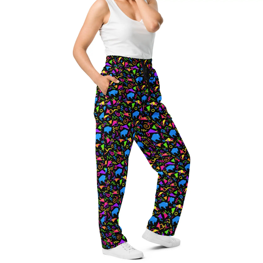 Side view of Buffalo NY patterned pants with bright neon geometric shapes, retro arcade-inspired print, and blue buffalo silhouettes in a bold all-over design.