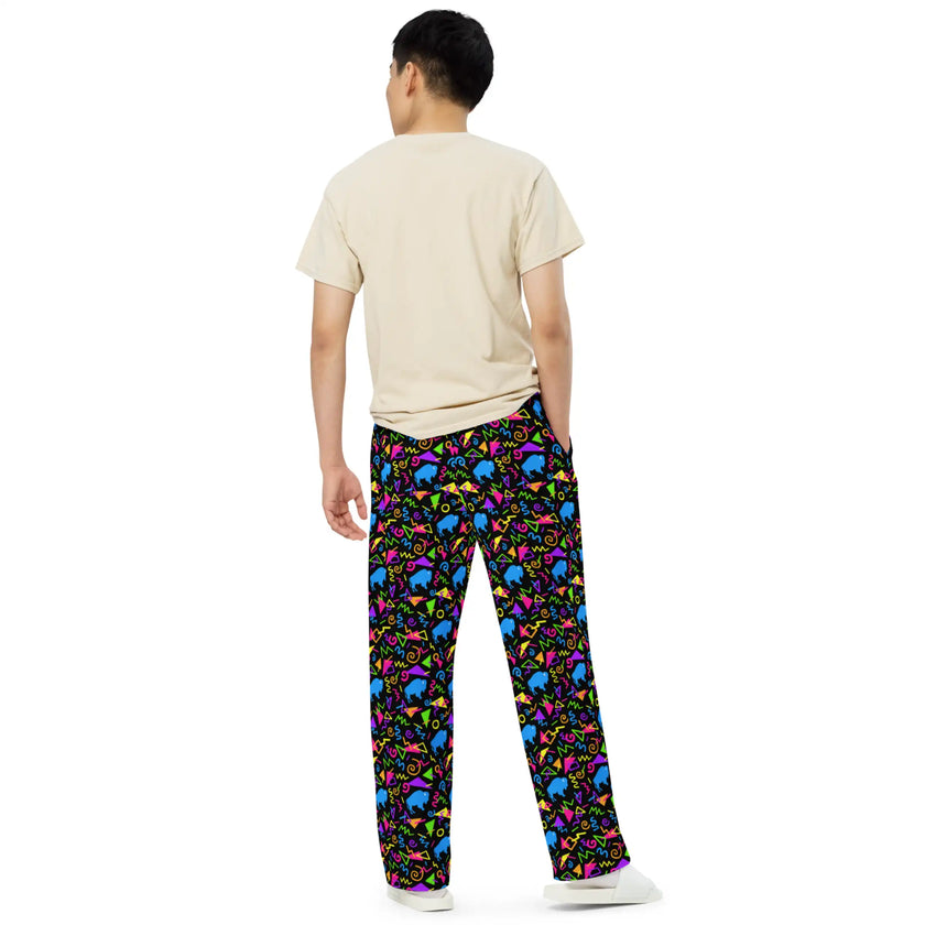 Man wearing Buffalo retro pants from the back featuring bright neon geometric print, nostalgic 80s and 90s inspired pattern, and Buffalo NY blue buffalo details.