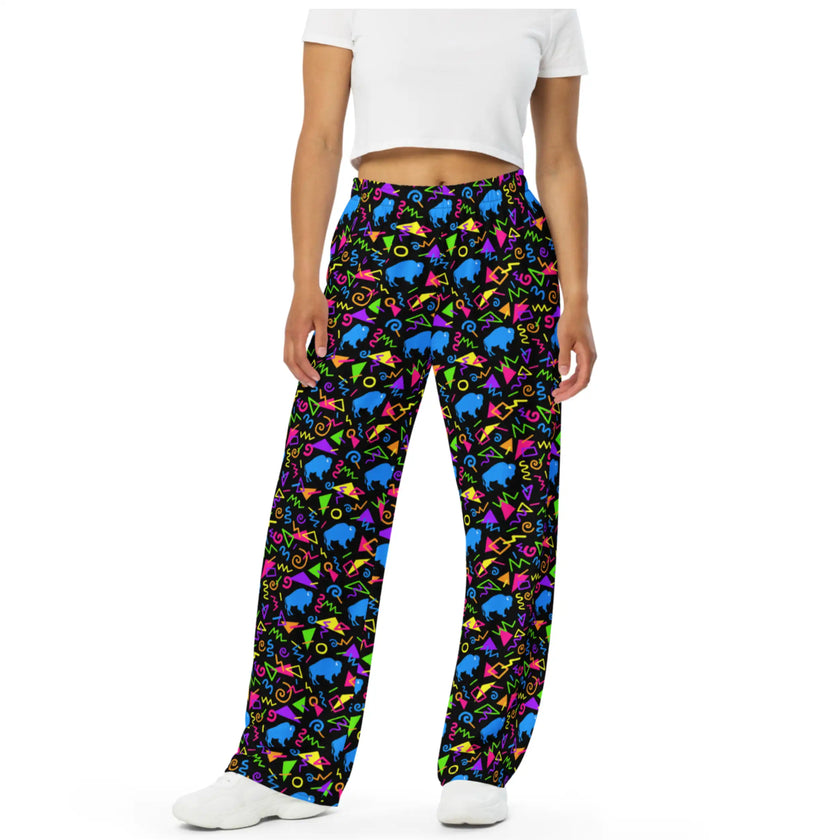 Woman wearing Buffalo retro neon pants featuring colorful geometric shapes and blue buffalo silhouettes, unique 80s and 90s inspired Buffalo NY fashion.