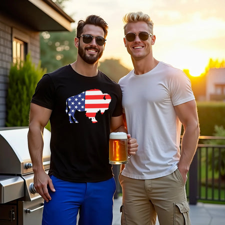Man wearing black Buffalo football t-shirt with American flag buffalo silhouette graphic standing with friend on backyard patio next to stainless steel grill at sunset, outdoor Buffalo lifestyle apparel scene.