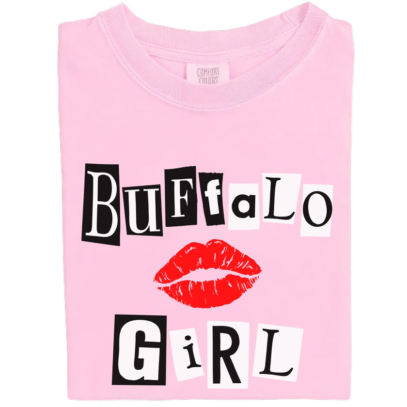 Folded light pink Buffalo Girl t-shirt with bold magazine-style lettering, giving mean-girl energy and Buffalo pride.