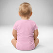 Back view of baby wearing pink Buffalo football ‘Let’s Go Buffalo’ bodysuit with soft cotton fit and snap closure detail.