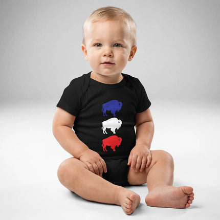 Baby wearing black Buffalo football baby bodysuit featuring vertical blue white and red buffalo silhouette design, front view game day outfit.