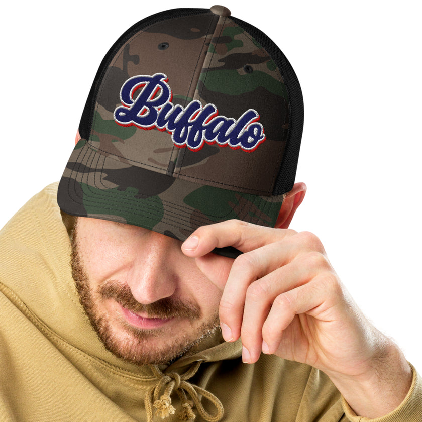 Man wearing a Buffalo Football camouflage mesh trucker hat with retro red white and blue embroidered Buffalo lettering, stylish outdoor and game day apparel.